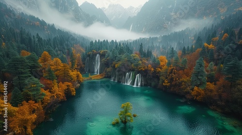 Aerial view of Jiuzhaigou Valley in China, featuring its multi-colored lakes, waterfalls, and snow-capped peaks surrounded by lush forest.      photo