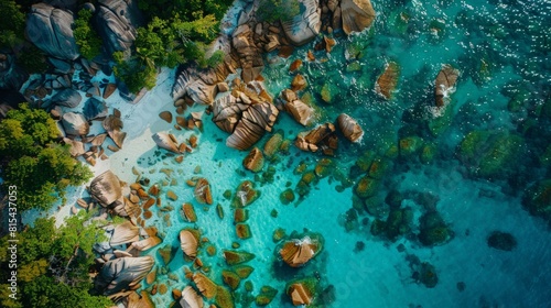 Aerial view of the Seychelles, featuring the granite boulders, white sandy beaches, and crystal-clear waters of Anse Source d'Argent. 