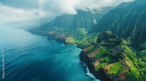 Aerial view of the Na Pali Coast in Hawaii, featuring the dramatic cliffs, lush green valleys, and the deep blue waters of the Pacific Ocean. 