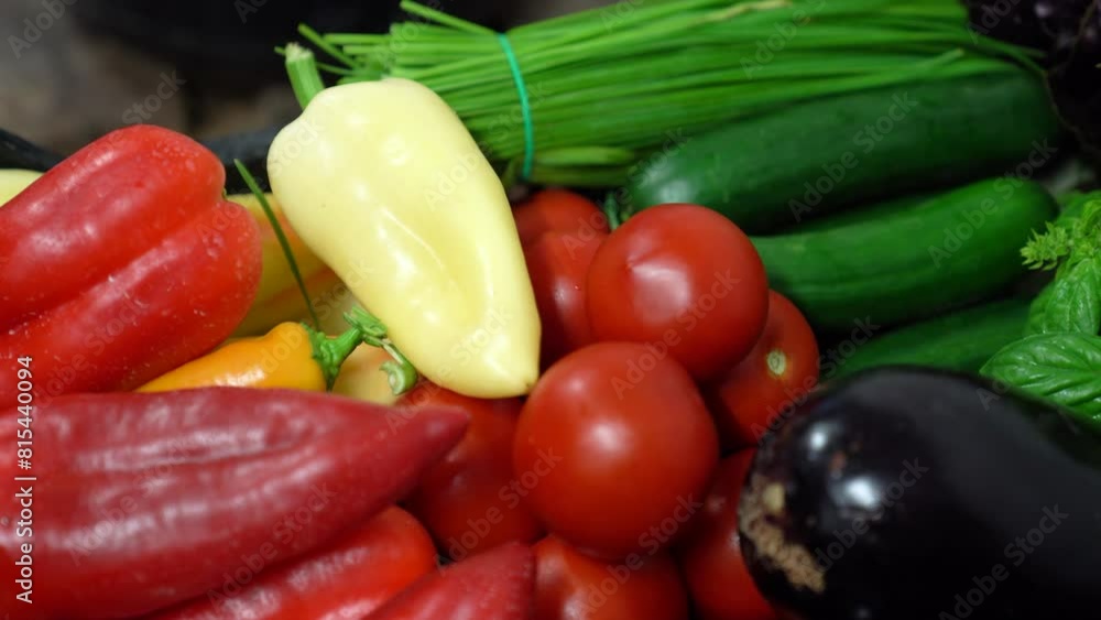 Closeup shot red yellow peppers green cucumbers eggplant long onion in a box Closeup shot red yellow peppers green cucumbers eggplant long onion in a box