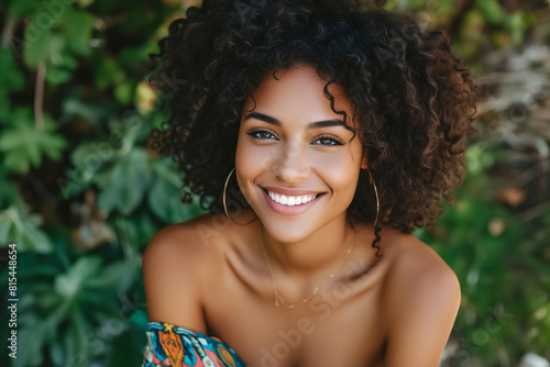A beautiful woman with curly hair smiling.