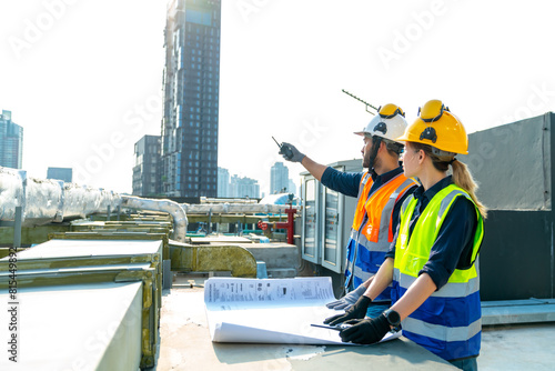 Fotografie Professional Asian man and woman teamwork engineer and foreman using blueprint working outdoor at construction site building rooftop