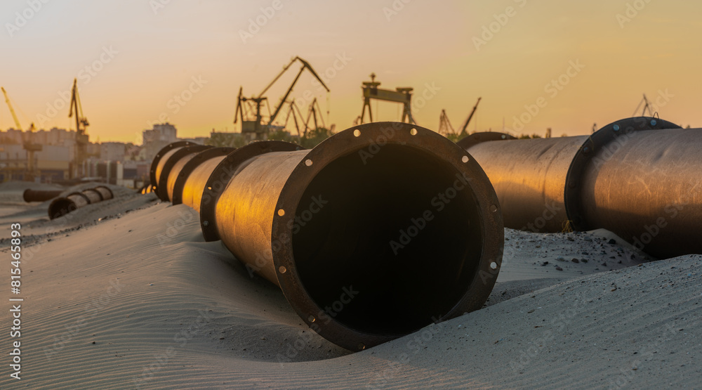 Industrial landscape:sunset over industrial areas,pipelines running through sandy desert Industrial landscape:sunset over industrial areas,pipelines running through sandy desert