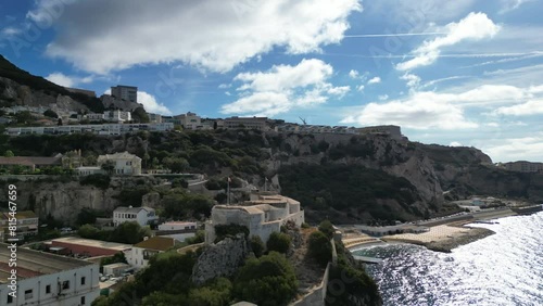 A beautiful 4K drone shot orbiting around Parson's lodge with the bay of Gibraltar included and the rock of Gibraltar on a partly cloudy day.