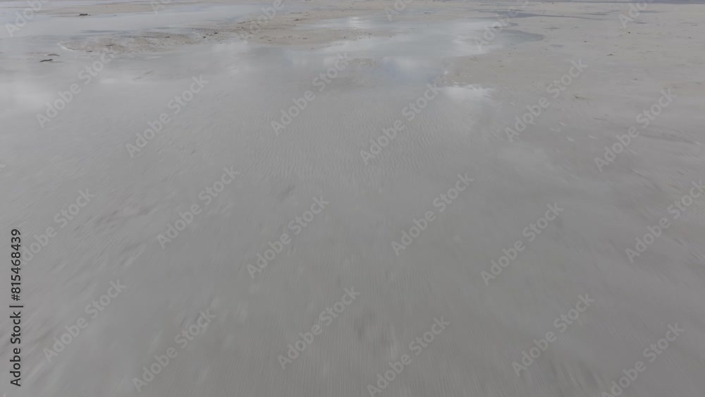 Low aerial pan up and reveal of mountains bordering the Great Salt Lake, Utah on a sunny spring day. Low aerial pan up and reveal of mountains bordering the Great Salt Lake, Utah on a sunny spring day.