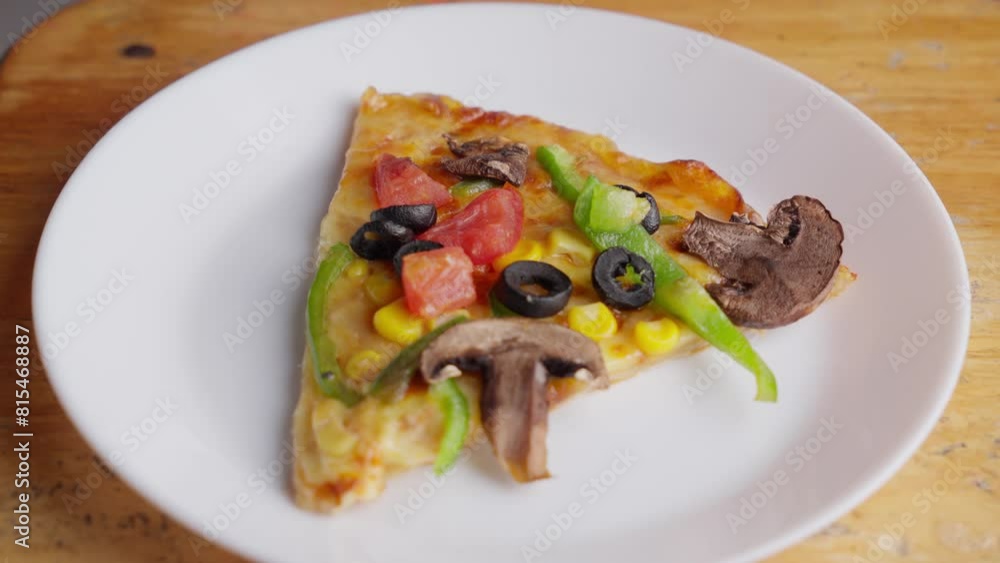 Zoom at Vegetarian pizza with olives, mushrooms, green paprika, tomato, and corn Zoom at Vegetarian pizza with olives, mushrooms, green paprika, tomato, and corn