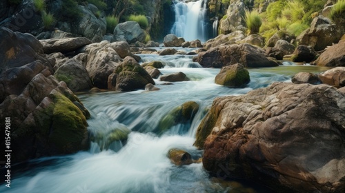 Beautiful shot of waterfalls flowing near lots stones