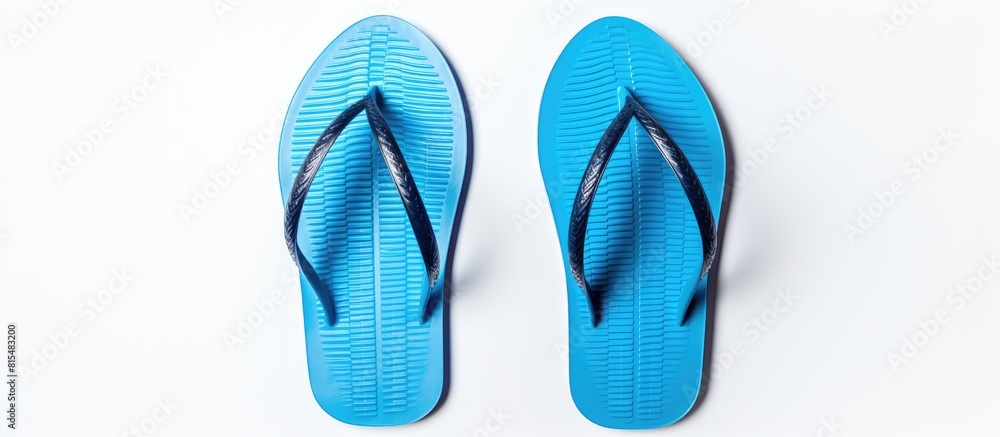 A top view of blue flip flops against a white background with plenty of empty space in the image. Creative banner. Copyspace image A top view of blue flip flops against a white background with plenty of empty space in the image. Creative banner. Copyspace image