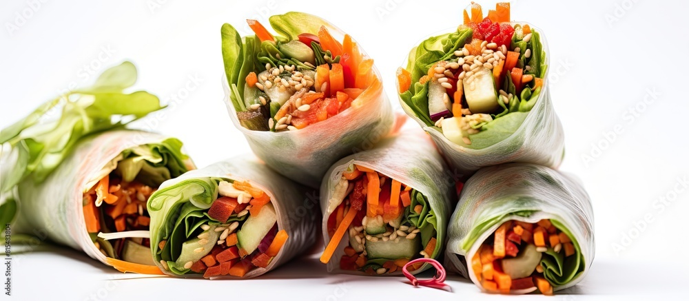A copy space image of healthy vegetable spring rolls with sesame seeds presented on a clean white background symbolizing weight loss and a nutritious diet A copy space image of healthy vegetable spring rolls with sesame seeds presented on a clean white background symbolizing weight loss and a nutritious diet