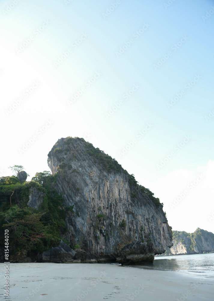 Landscape view of the rock cliff beside sandy beach at Had Yao beach (Long Beach), Trang province, Thailand.