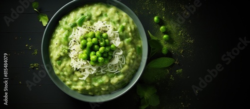 A bowl of homemade creamy green pea risotto photographed from above with plenty of space for text on the side. Creative banner. Copyspace image photo