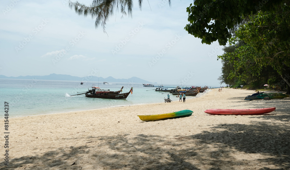 Fototapeta premium Beach on Koh Kradan Island in the Andaman Sea. Seafarers and tour boats and island scenery.
