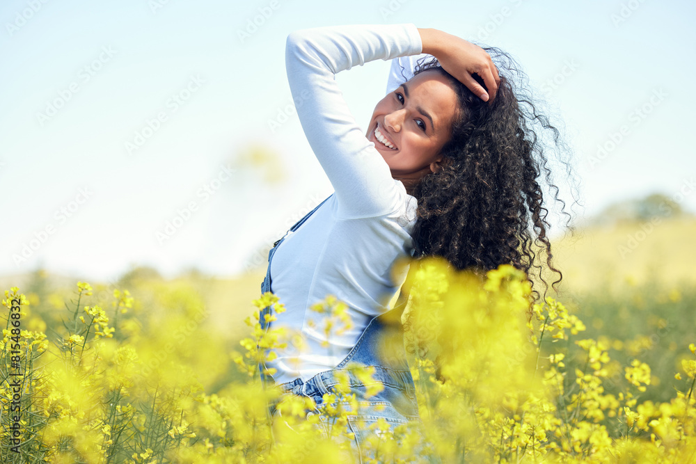 Woman, portrait and smile in nature with flowers for adventure, travel and holiday in countryside. Gen z, female person and environment for sustainability, happiness and sunshine in field for spring Woman, portrait and smile in nature with flowers for adventure, travel and holiday in countryside. Gen z, female person and environment for sustainability, happiness and sunshine in field for spring