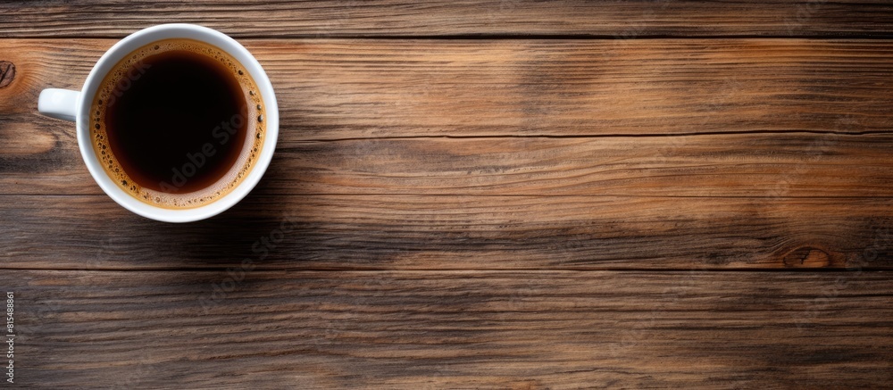 Top view copy space image of a coffee cup resting on a wooden background Top view copy space image of a coffee cup resting on a wooden background