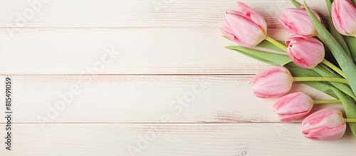 Copy space image of a pink tulip on a white wooden background with the Polish words Dzien Matki Mother s Day on a Mother s Day card