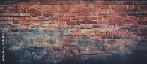 A vintage toned styled background with a vignette effect featuring a brick wall for texture and copy space image