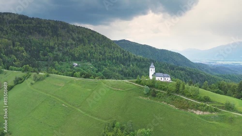 Wallpaper Mural Flying away from Catholic church at the top of the hill, the St. Primus and St. Felician church at Jamnik, Slovenia. Hiking, pilgrimage, travel and tourism concepts. Drone shot, 4K, 60FPS Torontodigital.ca