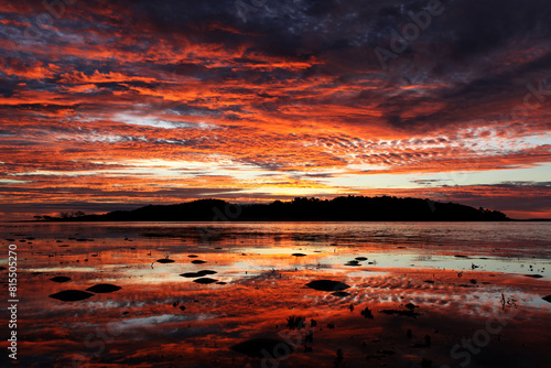 Beautiful vibrant orange sunrise over an island in Seisia on the Cape York Peninsula, Queensland Australia photo