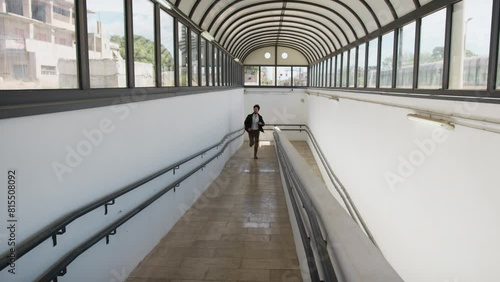 Boy Runs On The Ramps Of The Station Underpass To Catch The Late Train photo