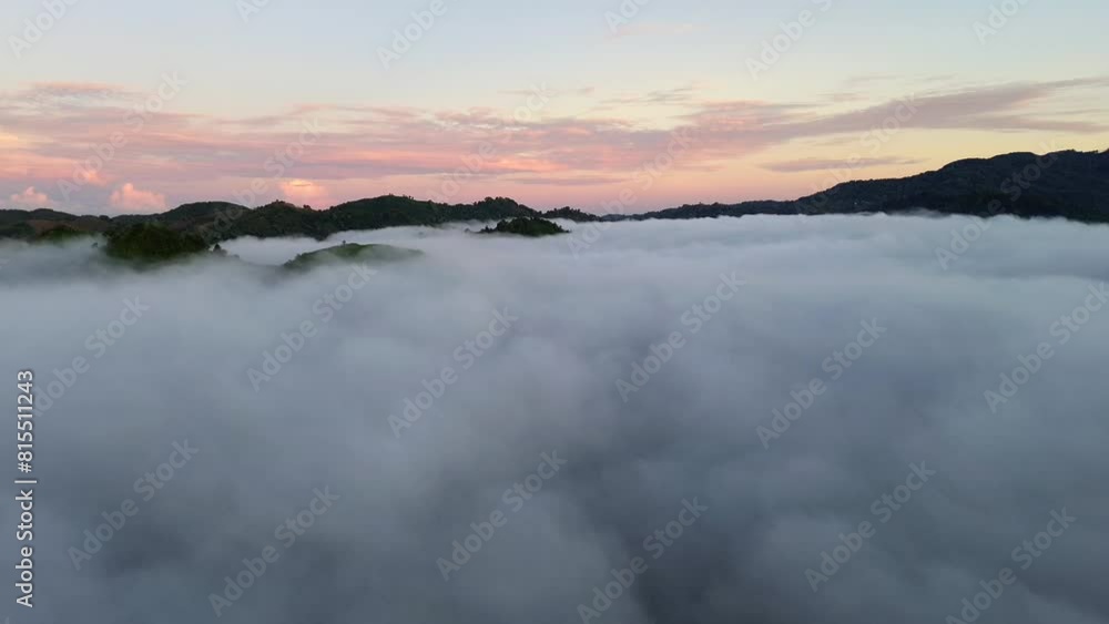 Aerial view of fog in the mountain at Gorontalo, Indonesia. Sunrise over the clouds in the morning Aerial view of fog in the mountain at Gorontalo, Indonesia. Sunrise over the clouds in the morning