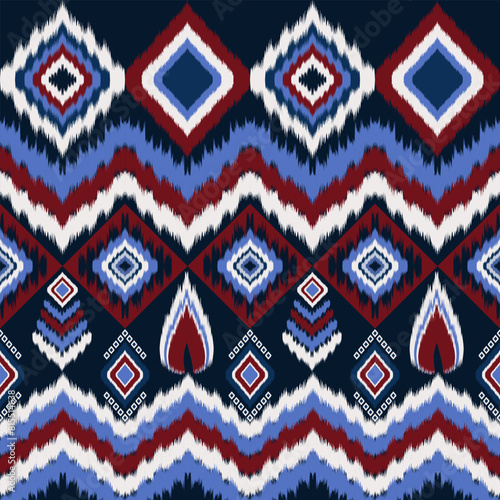 Ikat geometric seamless pattern in red, blue, and white on black background. Geometric shapes in squares, rectangles, and diamonds. 