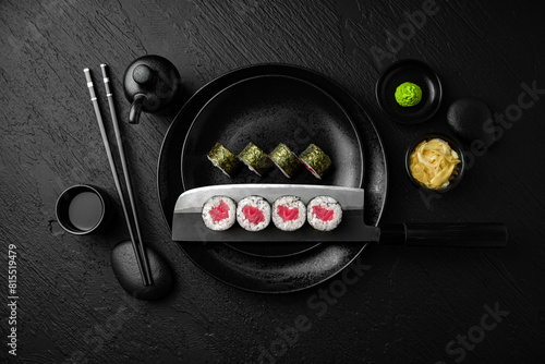 Tuna Maki. Sushi composition on black background. The Art of Japanese Cuisine. Food photography for menu and sushi bar decoration