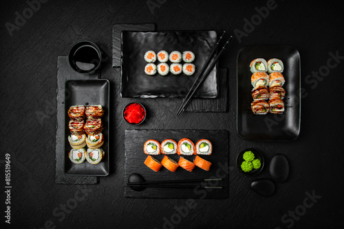 Sushi set composition on black background. The Art of Japanese Cuisine. Food photography for menu and sushi bar decoration