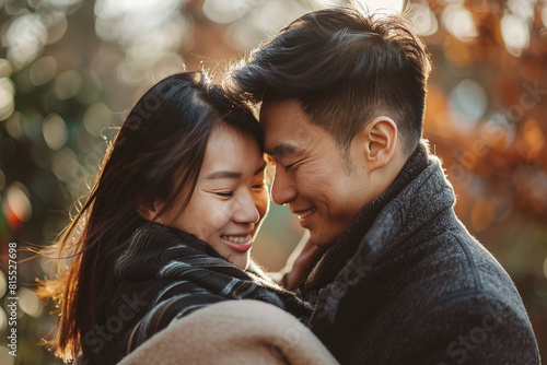 An Asian couple in a warm embrace