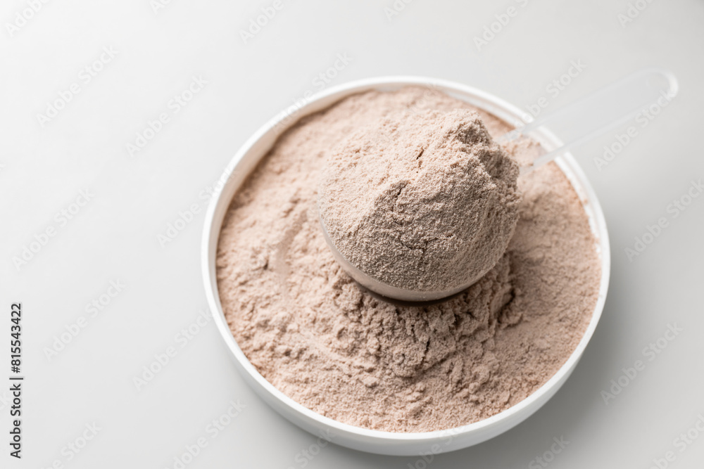 Whey protein powder in measuring scoop Whey protein powder in measuring scoop