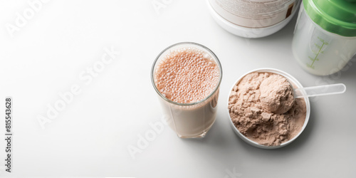 Protein drink cocktail in a glass and whey protein powder in a measuring scoop