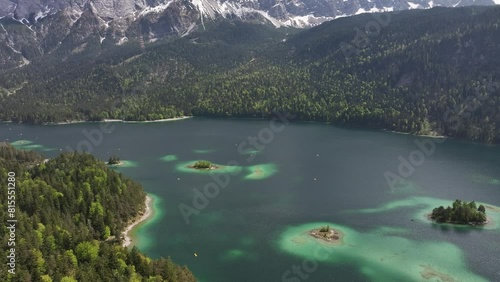 Wallpaper Mural Eibsee's clear turquoise waters, small islands, and dense forests with a backdrop of snow-capped mountains in Grainau, Germany Torontodigital.ca
