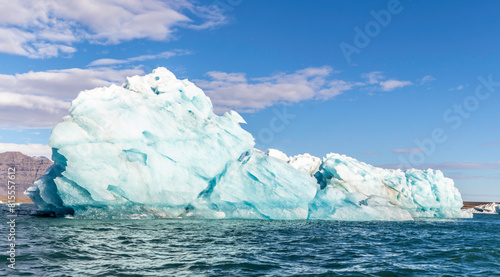 A large blue ice block floating in the ocean