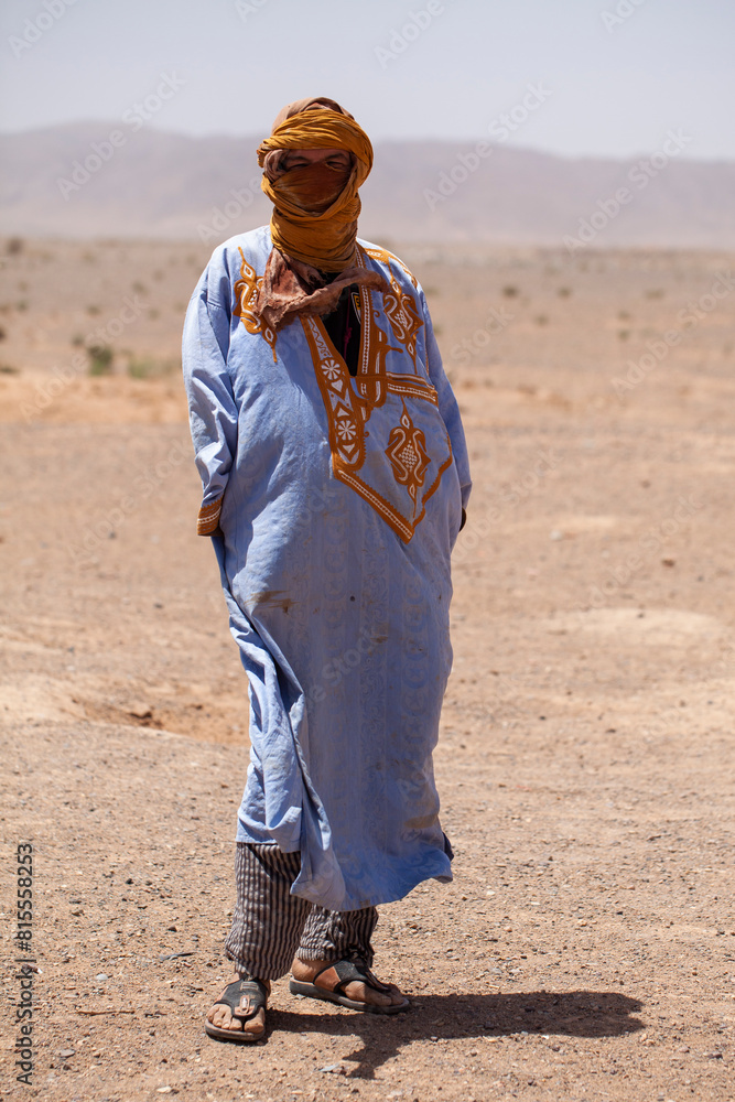 Berber man dressed in typical costume in the desert. South Morocco.