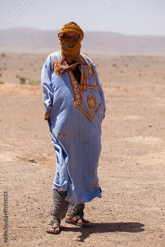 Berber man dressed in typical costume in the desert. South Morocco.
