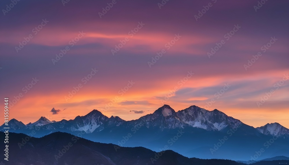 A mountain range outlined against a colorful sunse