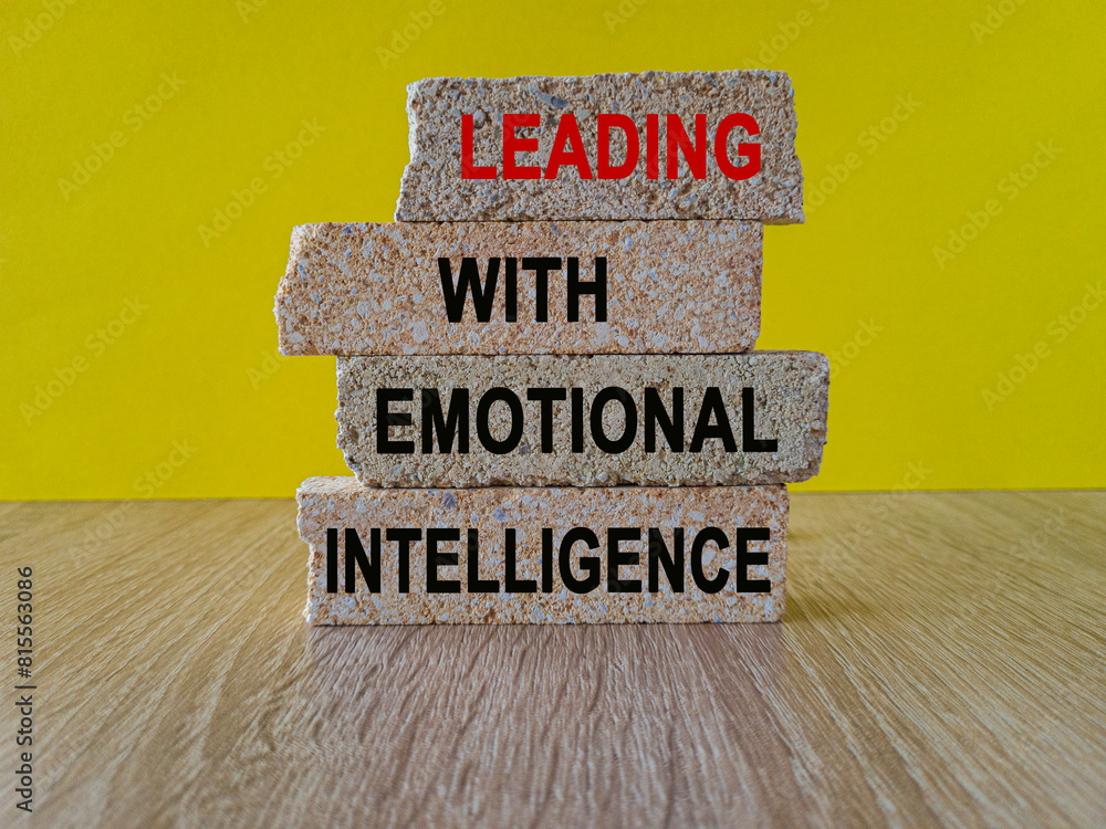 Leading with Emotional intelligence symbol. Concept words Leading with Emotional intelligence on brick blocks on a beautiful wooden table yellow background. Business concept.