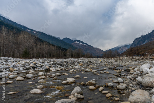 Beas River, with a background of landscape with lakeand  snow-covered mountains, in Manali, Himachal Pradesh, India 