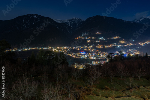 High-resolution stock images of Manali night city view in front of snow-covered mountains from a hotel room