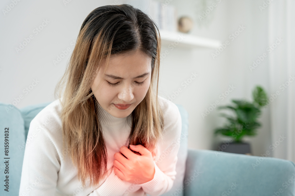 hand hold chest with heart attack symptoms, asian woman have chest pain caused by heart disease, leak, dilatation, enlarged coronary heart, press on the chest with a painful expression hand hold chest with heart attack symptoms, asian woman have chest pain caused by heart disease, leak, dilatation, enlarged coronary heart, press on the chest with a painful expression