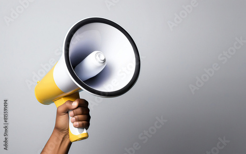 hand with a megaphone on a gray background with space for text