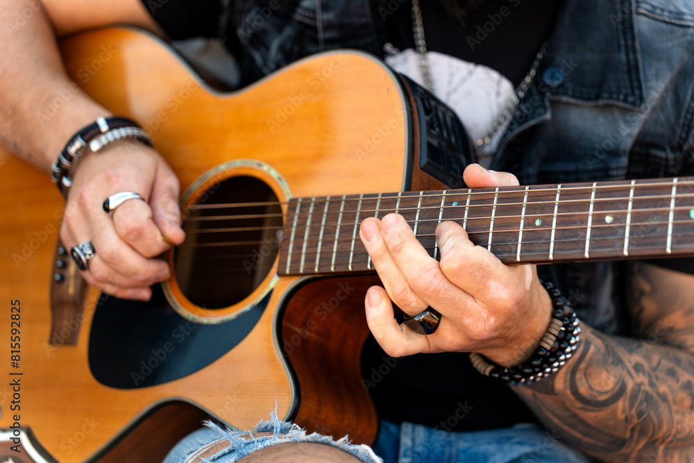 Fototapeta premium Closeup of the hands of a rock guitarist