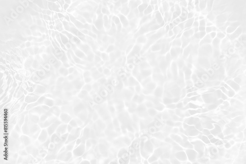 White water with ripples on the surface. Defocus blurred transparent white colored clear calm water surface texture with splashes and bubbles. Water waves with shining pattern texture background. 