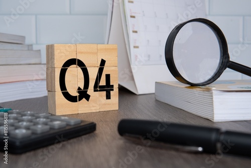 Close up image of wooden cubes with alphabet Q4 on office desk. Fourth quarter concept. photo