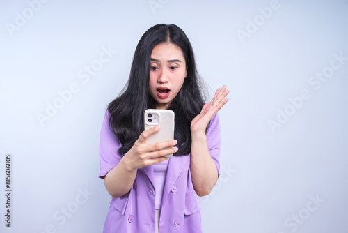 Surprised Young Woman Using Smartphone Isolated on Grey Background