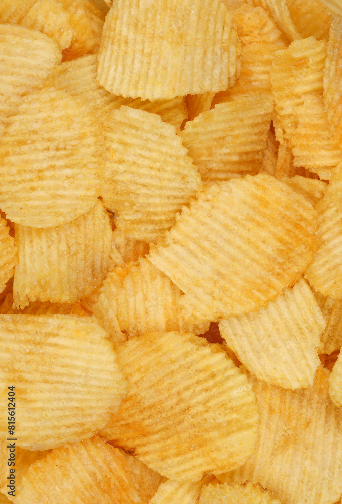 Crispy potato chips in macro. Golden fried potatoes close up. Potato snack for unhealthy fast food. Crispy potato chips in macro. Golden fried potatoes close up. Potato snack for unhealthy fast food.