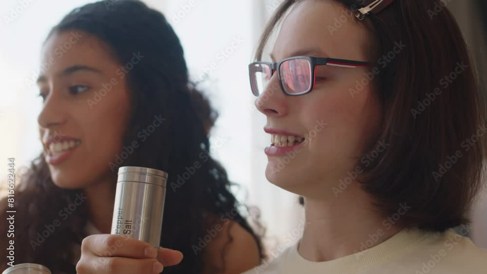 Medium closeup of positive diverse teenage girls having fun singing karaoke at home. One of girls having cerebral palsy Medium closeup of positive diverse teenage girls having fun singing karaoke at home. One of girls having cerebral palsy
