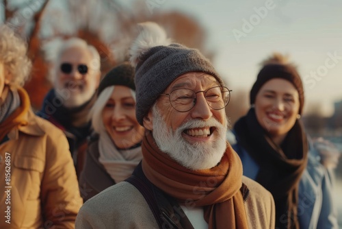 Happy senior man with his friends walking in the park. Group of friends spending time together.