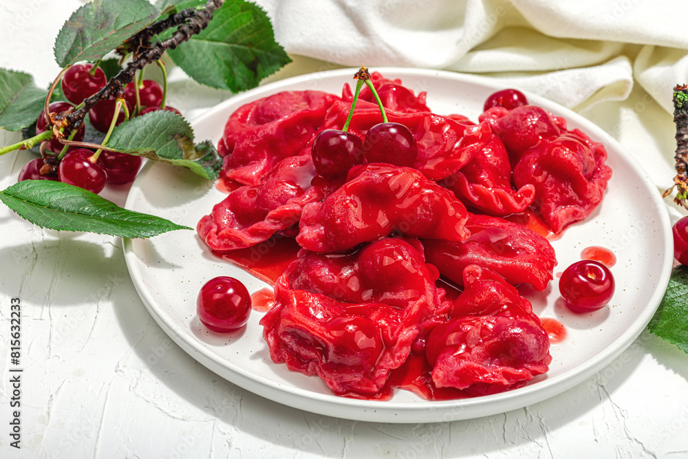 Dumplings, filled fresh cherries. Ripe fruits, sweet sauce, sour cream. Traditional Ukrainian dish Dumplings, filled fresh cherries. Ripe fruits, sweet sauce, sour cream. Traditional Ukrainian dish