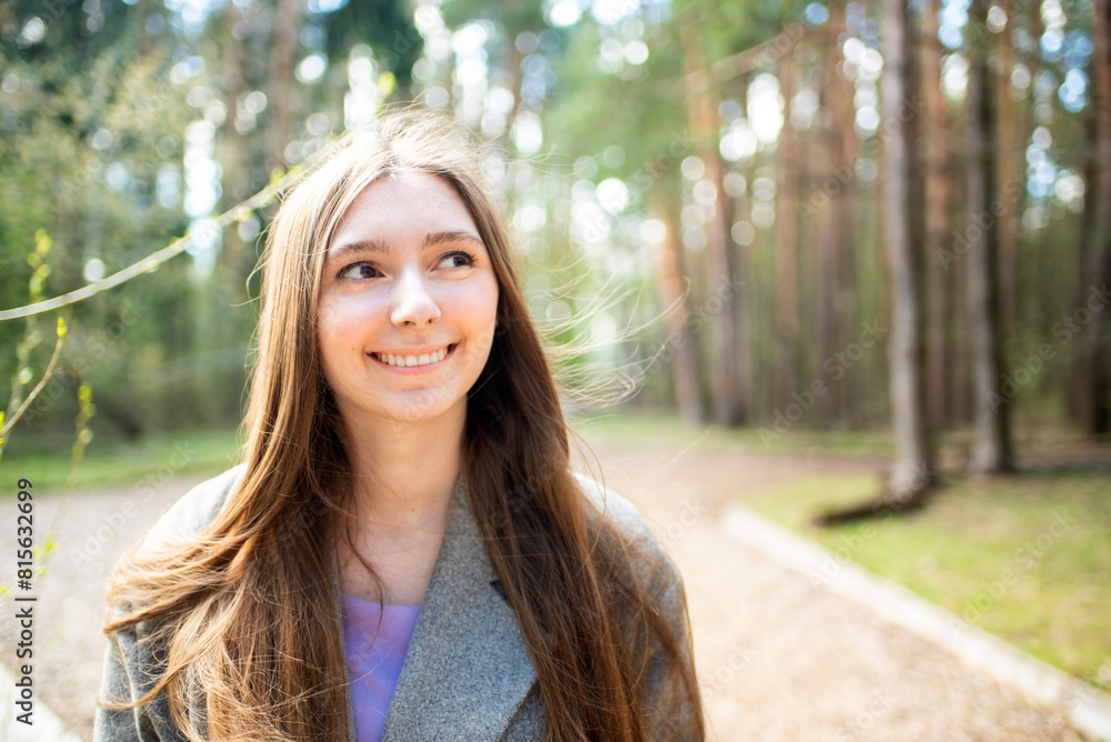 Portrait of a beautiful teenage girl, young woman with long hair in the park Portrait of a beautiful teenage girl, young woman with long hair in the park