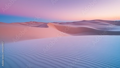 A calm desert landscape at dusk featuring soft purple and blue hues in the sky. 